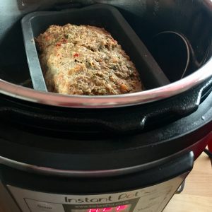 Instant Pot pressure cooked Meat Loaf - Feisty Tapas in a rectangular silicone mould inside the Instant Pot's stainless steel inner pot. Shown in the photo is the Instant Pot LUX 6 in 1. A delicious meat loaf with hidden veg, great for leftovers the next day!