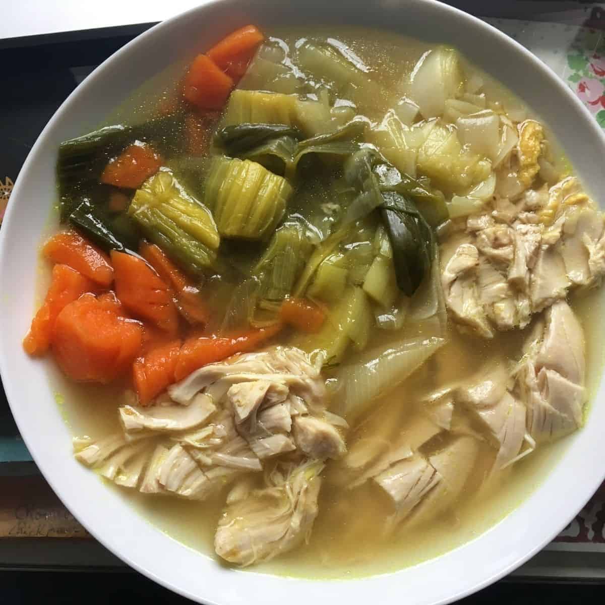 Delicious and super easy Instant Pot Chicken, Leek and Carrot soup. Served chunky in a deep white plate