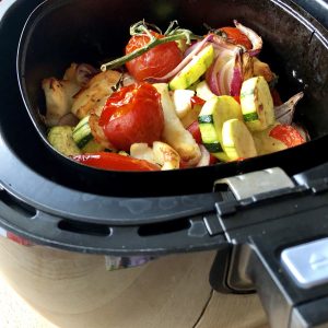 Photo showing the delicious Air Fryer Roasted Mediterrean Vegetables with Halloumi Cheese recipe by Feisty Tapas in the drawer of a black Philips air fryer