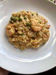 Instant Pot Prawn Trout and Pea Risotto looking served on a white plate