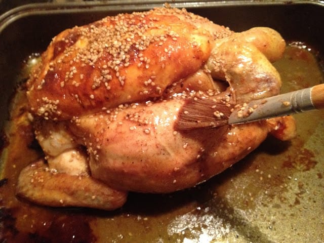 Maple-Glazed Roast Chicken with Sesame Seeds - Glazing with a brush