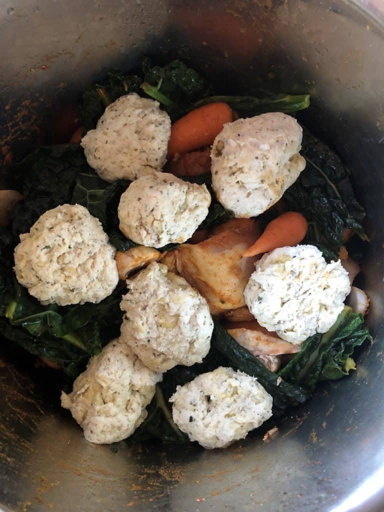 Instant Pot Chicken Stew with Suet-Free Dumplings - about to be pressure cooked. All the ingredients are in: chicken thigh fillets, carrots, cavolo nero, dumplings, etc. in the Instant Pot DUO's stainless steel inner pot. Ready to be pressure cooked
