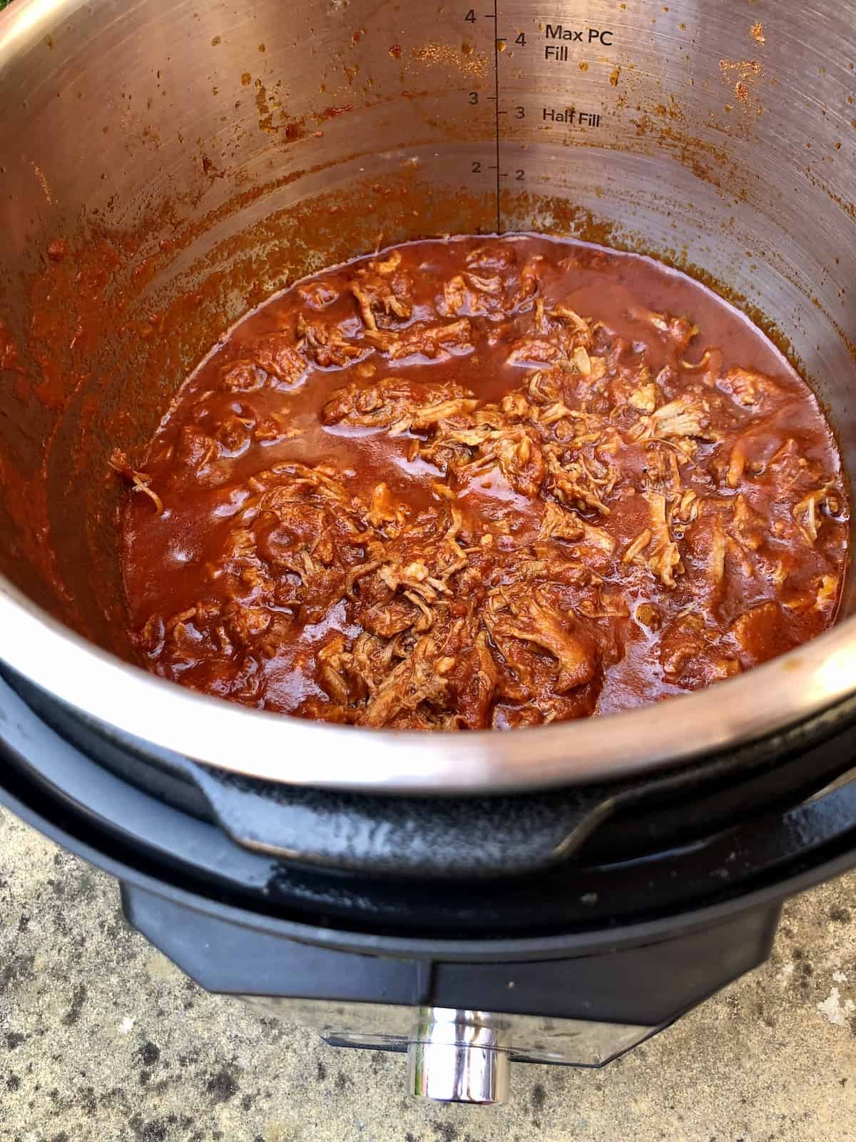 Photo of the BBQ Pulled Pork seen from above inside an Instant Pot Duo Evo Plus electric pressure cooker