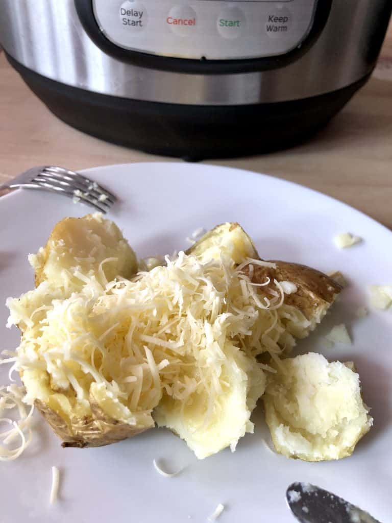 Jacket potato cooked in Instant Pot Duo Crisp and served with butter and cheese