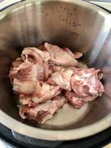 Pork shoulder cut into chunks in inner pot for Feisty Tapas Instant Pot Pulled Pork recipe