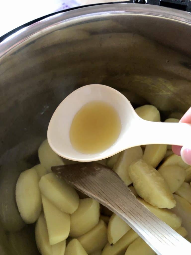 Removing some of the stock from the pressure cooked potatoes