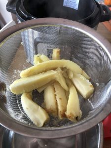 Prepared parsnips in mesh steamer basket - roughed up