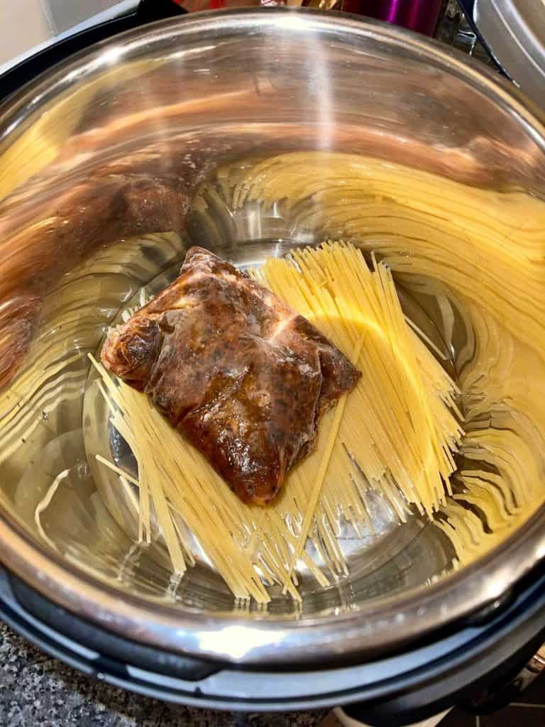 All-in-one one pot Instant Pot Mushroom Bolognese from frozen with pasta - before closing the lid