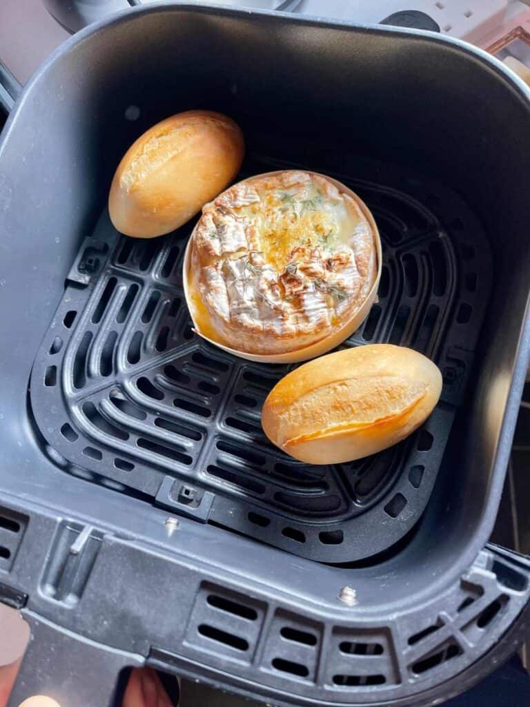 Air Fryer Baked Camember with two crusty rolls seen in the black Instant Vortex drawer from above