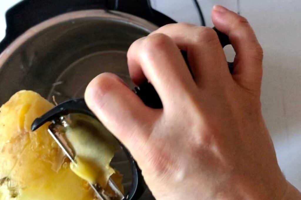 Swede being easily peeled with an OXO Good Grips y peeler, seen from above