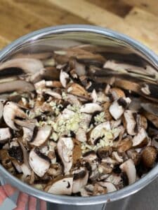 All ingredients for garlic mushrooms (Spanish Setas al Ajillo) inside the Instant Pot stainless steel inner pot