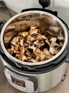 Garlic Mushrooms before pressure cooking. Seen from above in the stainless steel inner pot of the Instant Pot Duo multicooker
