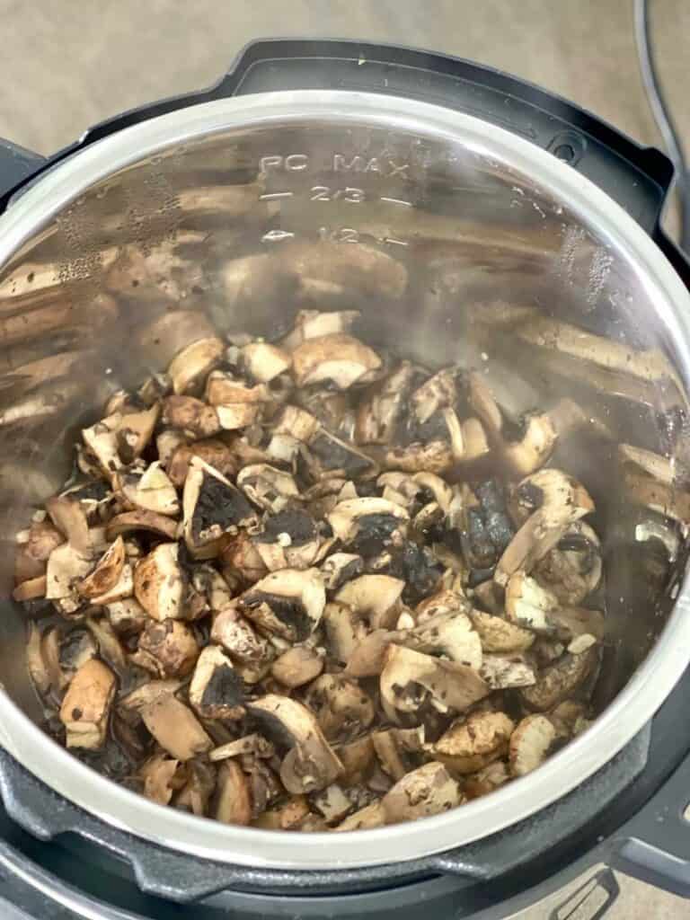 Garlic Mushrooms after pressure cooking seen from above in the stainless steel inner pot of the Instant Pot Duo multicooker