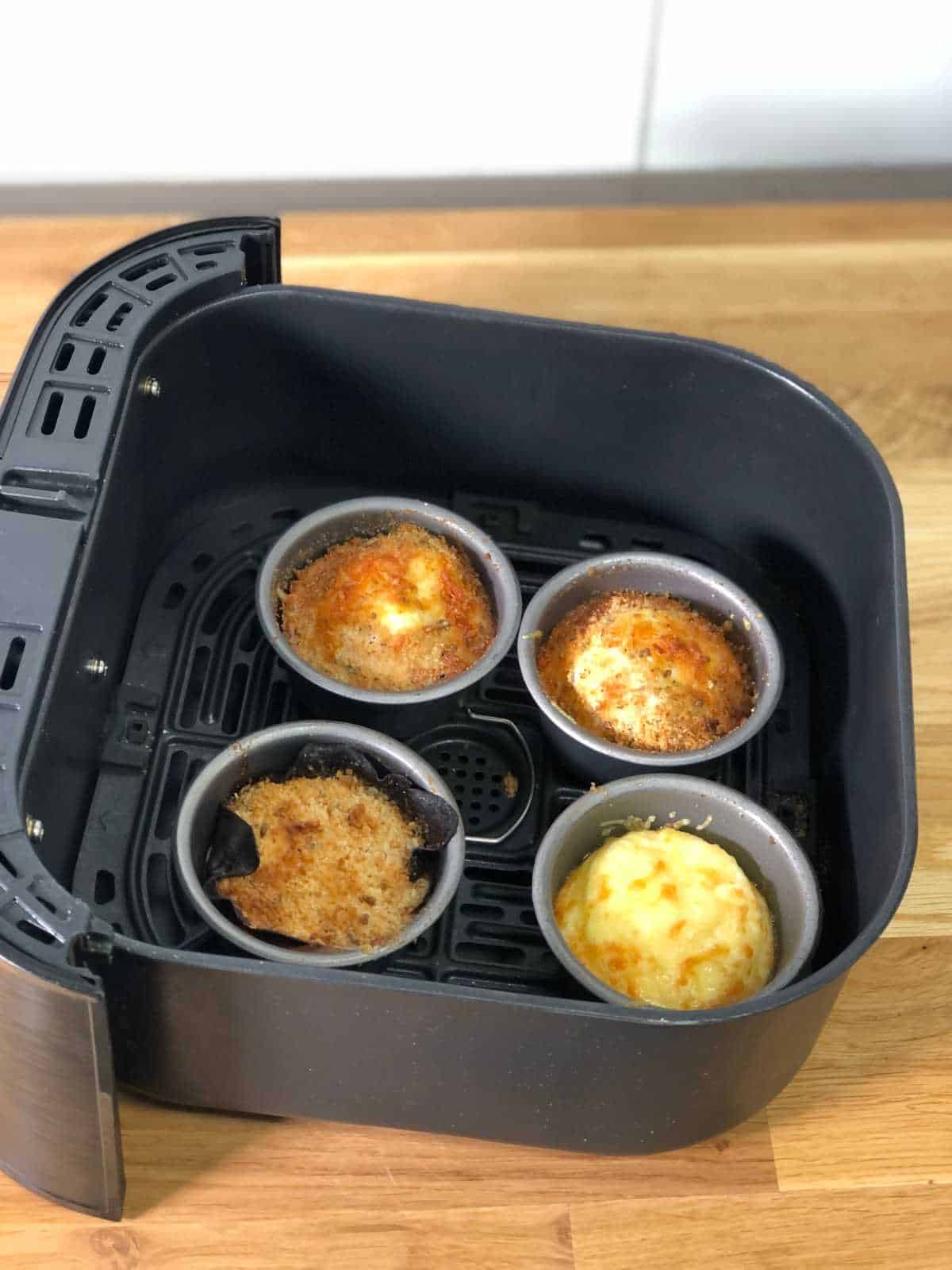Air fried baked egg pots still in the basket, ready to eat