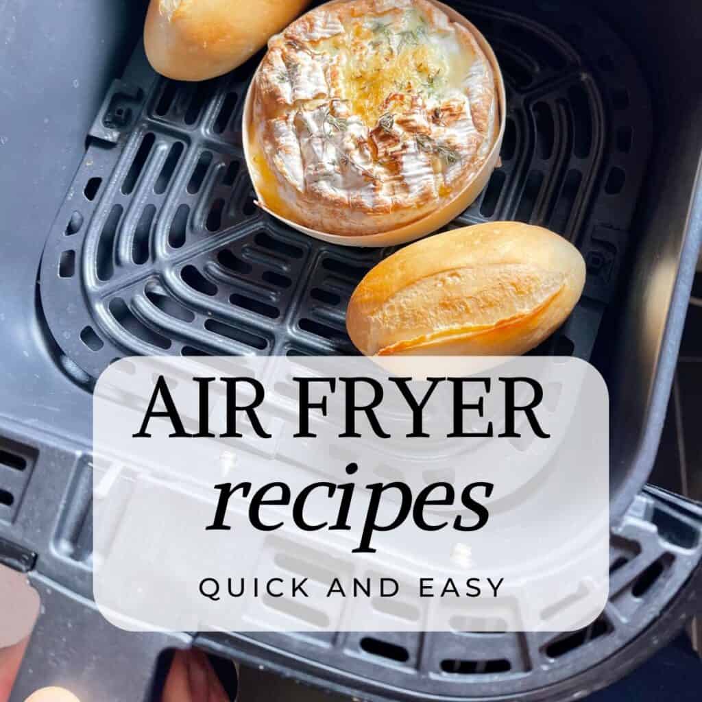 Graphic of a baked camembert with 2 bread rolls seen inside an air fryer basket from above. With the words Air Fryer Recipes, quick and easy