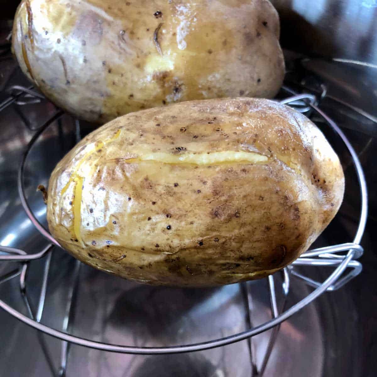 Baked potatoes seen on the trivet of the Instant Pot Duo Crisp