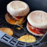 Photo of McMuffins and hash browns seen in the air fryer basket (this is the Instant Vortex basket)