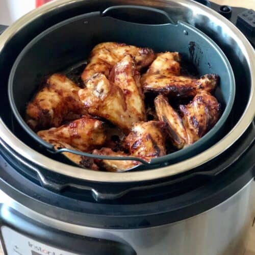 Photo of air fried chicken wings seen from above inside the air fryer basket of the Instant Pot Duo Crisp