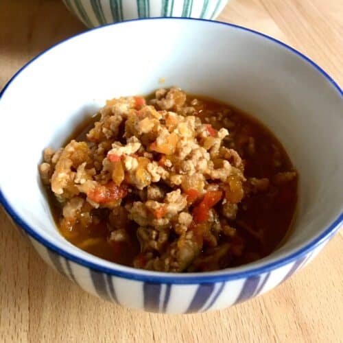 Photo of the Instant Pot Thai Pork larb served inside a blue and white stripy bowl