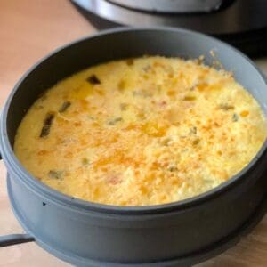 Photo of the delicious Instant Pot Duo Crisp Quiche just cooked and still inside the cake pan