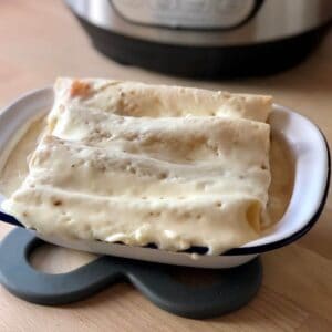 Photo of the pressure cooked tuna cannelloni ready to each in an oblong white enamel dish