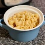 Image of the Mac and Cheese inside a mini casserole dish with an Instant Pot in the background