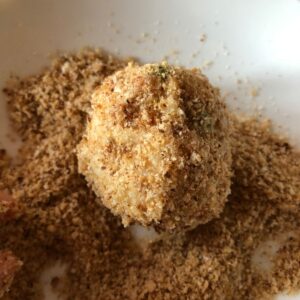 Photo of an arancini rice ball coated in the breadcrumbs