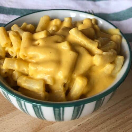 Photo of the Thermomix Vegan Mac and Cheese served in a white bowl with green stripes on the outside