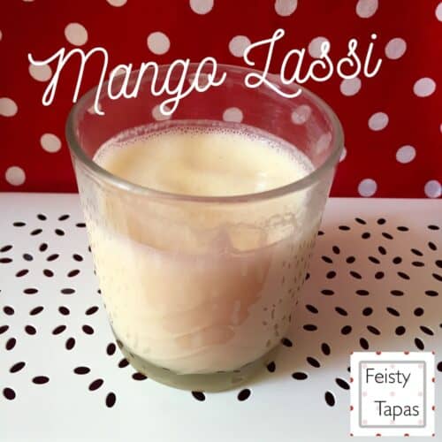 Photo of a glass of mango lassi with the words Mango Lassi above it and the Feisty Tapas logo on the bottom right