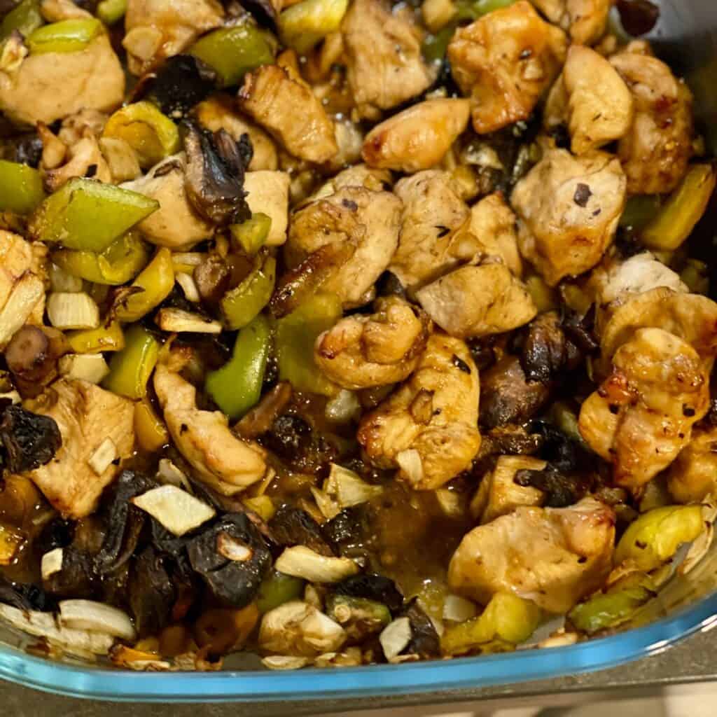 The chicken in oyster sauce at the end of air frying still in the glass container of the Ninja Crispi