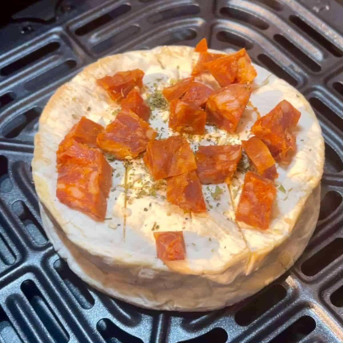 whole camembert inside air fryer drawer topped with diced chorizo, no wooden box so this one is the one that leaked (info in post)