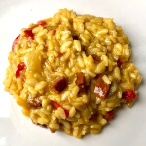 Chorizo risotto served on a white plate