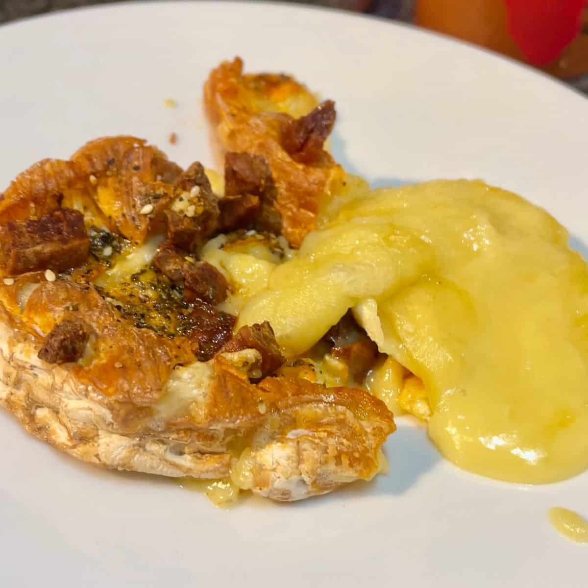 camembert which has leaked with the melted cheese spilling to the right
