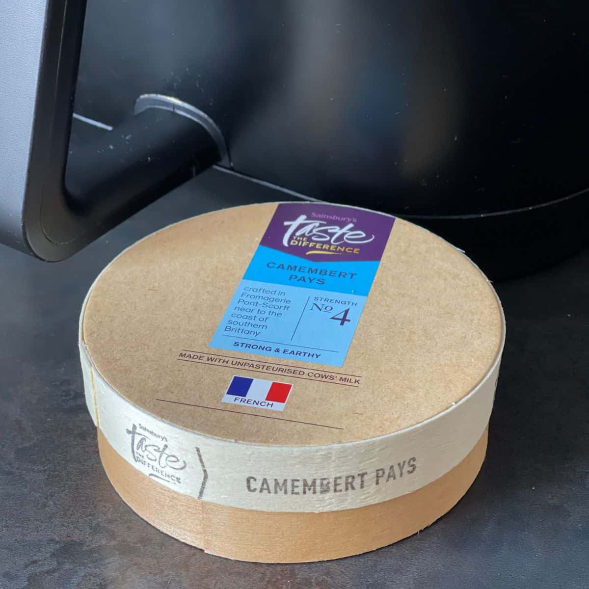 wooden Camembert box in front of an air fryer