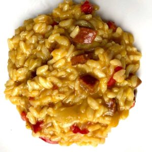 Chorizo risotto served on a white plate