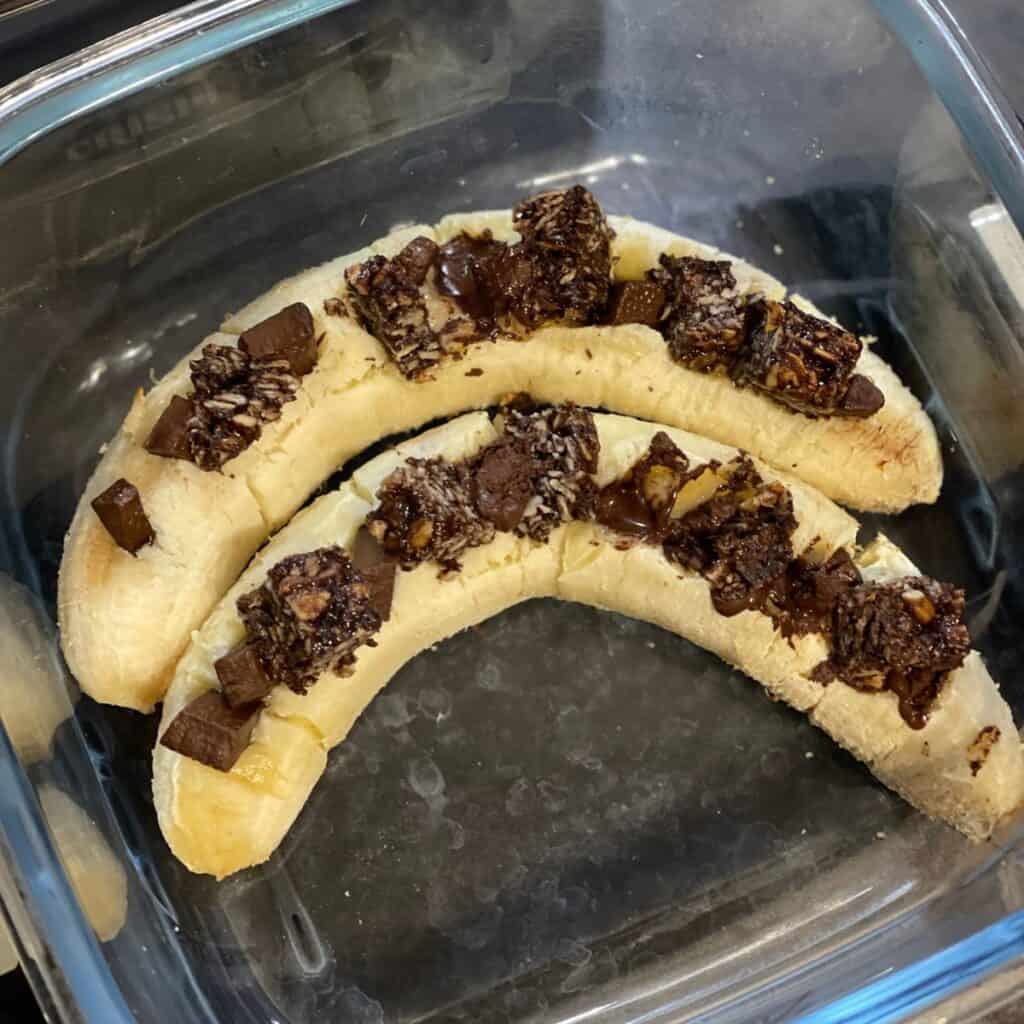 Two bananas inside the small glass base of the Ninja Crispi, this time they have been loaded with dark chocolate pieces and chunks of Graze Cocoa Vanilla oat boosts