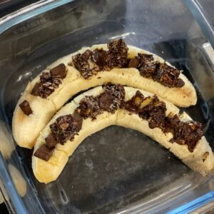 Two bananas inside the small glass base of the Ninja Crispi, this time they have been loaded with dark chocolate pieces and chunks of Graze Cocoa Vanilla oat boosts
