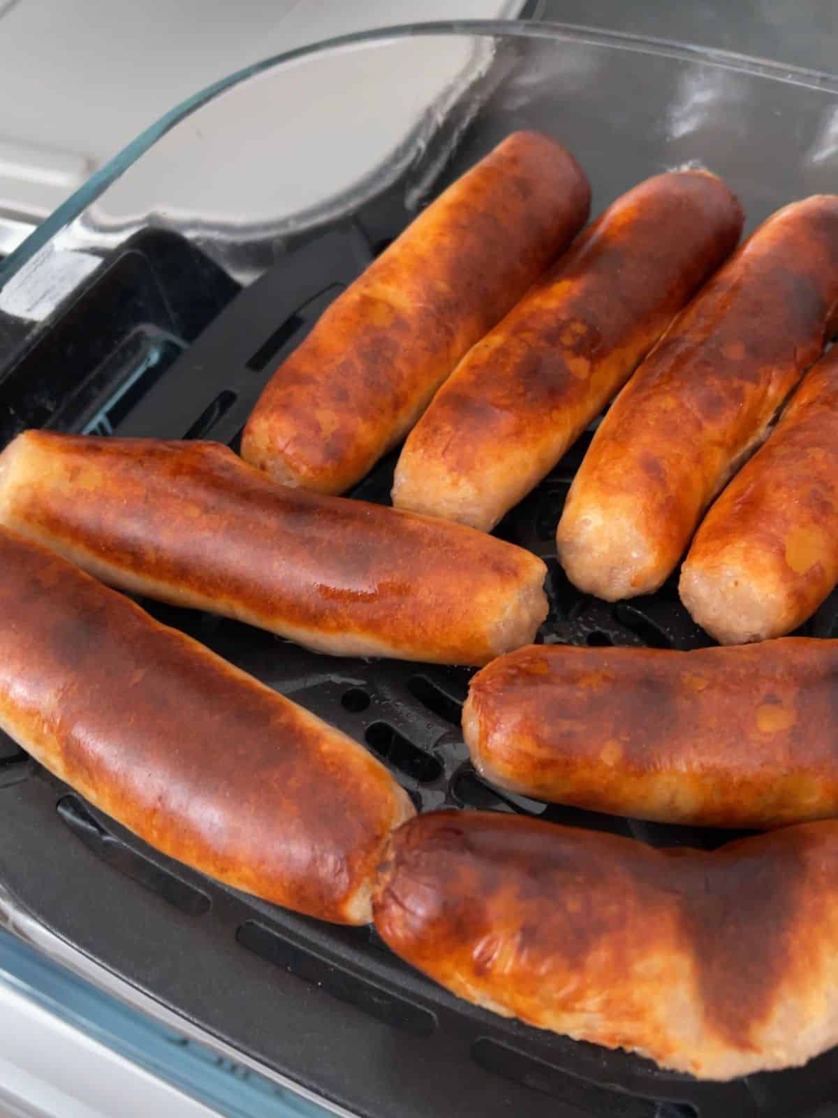 Sausages after air frying without flipping half way, they look a bit burnt on top but then again some people love them burnt. The sausages are still inside the Ninja Crispi Pro glass dish